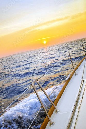Fototapeta na wymiar Sailing in sunset