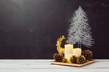 Candles And Pine Corn Decorations On Wooden Table For Christmas