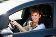 Woman and dog driving car