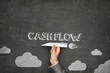 Cash flow concept on blackboard with paper plane