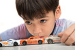 © wckiw - Little boy playing with car toy on  the table