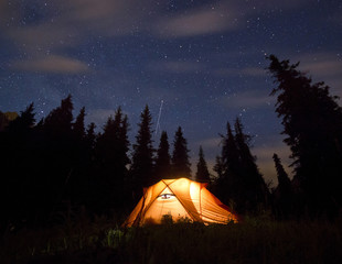 stars above the mountains with tent highlighted