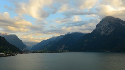 Wall Mural - Aerial view of the mountain landscape and lake. Below a small town in central Switzerland