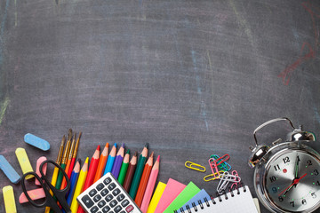 School supplies on blackboard background