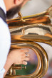 detail on a hand plays tuba
