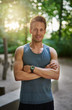 © Flamingo Images - Smiling Muscular Man with Arms Crossing Over Chest