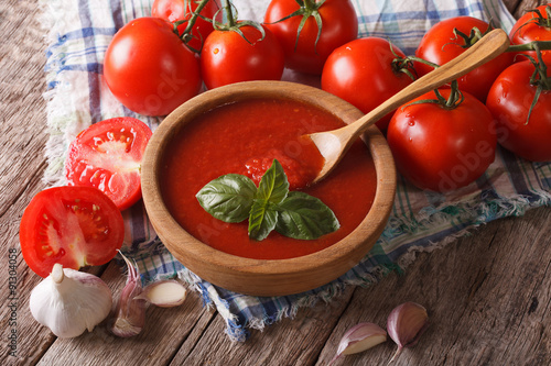 Fotografie, Obraz Homemade tomato sauce with garlic and basil closeup. Horizontal