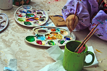 Children painting pottery at a workshop organized by the International Children's Day in Timisoara, Romania.