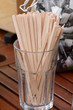 Wooden drink stirrers in glass on cafe table