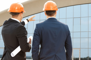 Two architect assessing their building progress