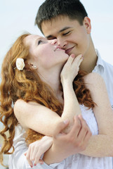 Fototapete - beautiful young couple in love near the sea