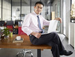 © imtmphoto - asian businessman sitting on desk with laptop computer in hand in office