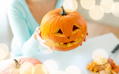 Wall Mural - close up of woman with pumpkins at home