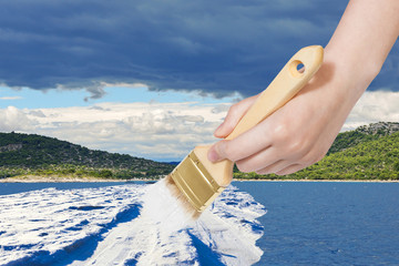 Poster - nature concept - seasons and weather changing: hand with paintbrush paints snow field in sea in summer