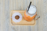 Fototapeta  - Top view of Iced milk Tea and cookie on wooden tray