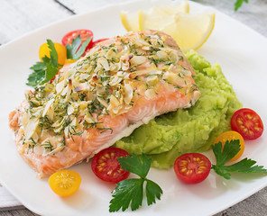 Baked salmon with cheese and almond crust and garnished with mashed potatoes and green peas