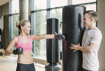 Sticker - smiling woman with personal trainer boxing in gym