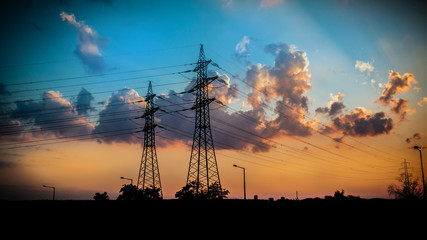 silhuettes of electricity pylons in the evening