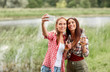 © Syda Productions - happy women taking selfie by smartphone outdoors