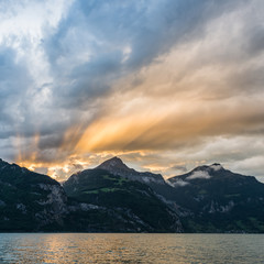 Wall Mural - Fantastic game of light and shadow. Storm over the mountain landscape