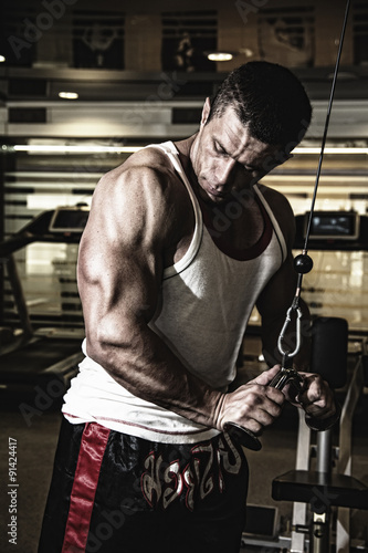 Plakat na zamówienie Bodybuilder trains the muscles in the gym