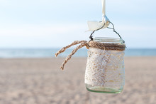 Glass Lantern Decorated With White Lace Hanging On Wedding