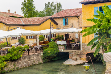 Canvas Print - Waters and ancient restaurant of Italian medieval village