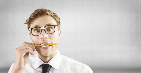 Poster - Composite image of geeky businessman biting a pencil