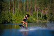 Young woman study riding wakeboarding on a lake