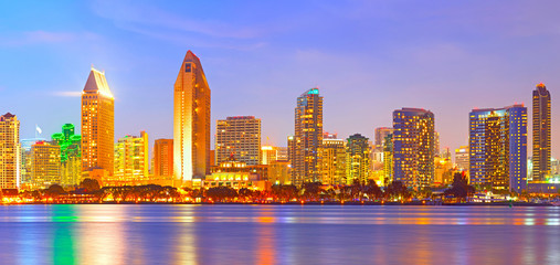 Wall Mural - San Diego California, city skyline at sunset on a beautiful summer night with lighted skyscrapers and downtown buildings