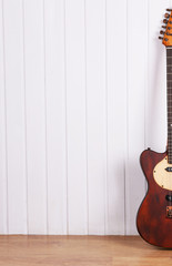 Wall Mural - Electric guitar on white wooden wall background