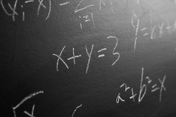 Maths formulas on blackboard background