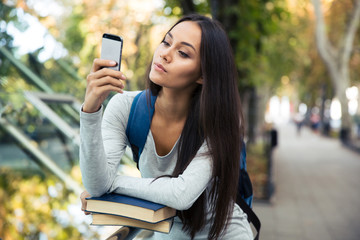 Canvas Print - Female student using smartphone