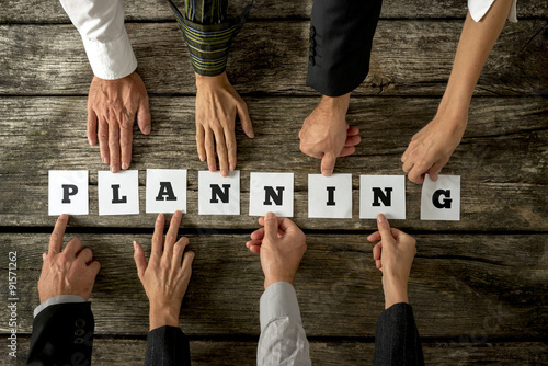 Fotografía Eight business people assembling the word Planning