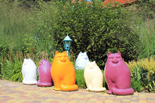 Multicolor Ceramic Cat Statues In The Garden