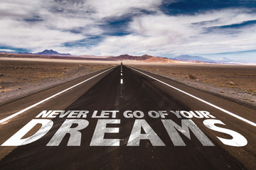 Never Let Go Of Your Dreams written on desert road