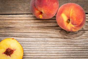 Wall Mural - peach fruits on weathered wood