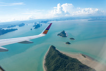 Island And Sea With Plane Wing