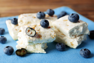 Wall Mural - Sweet nougat with nuts and blueberries on napkin close up