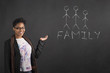 African woman holding hand out with a family  diagram  on blackboard background