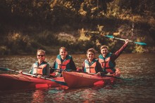 Group Of Happy People On A Kayaks