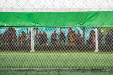 Wall Mural - Unrecgonizable audience watching kids soccer game