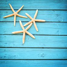 Starfish On The Blue Wooden Background