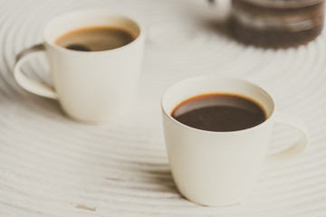 Wall Mural - Selective focus point on black coffee in white cup - vintage fil