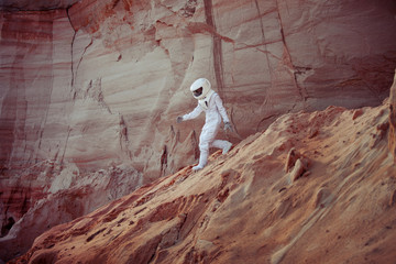 Wall Mural - futuristic astronaut on another planet, image with the effect of