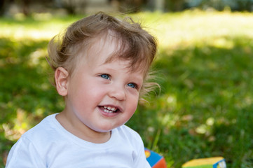 child with curly hair smiles