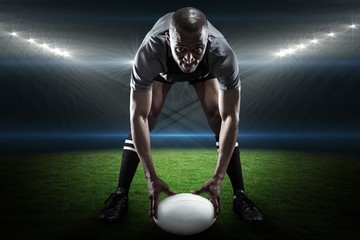 Poster - Composite image of portrait of sportsman holding ball