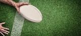Composite image of cropped image of a man holding rugby ball