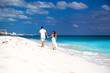 © photopixel - Young beautiful newlyweds on white sandy beach, rear view