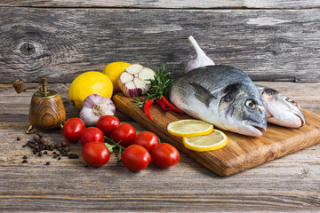 Raw fish with vegetables, ready to cook. Dorada fish 